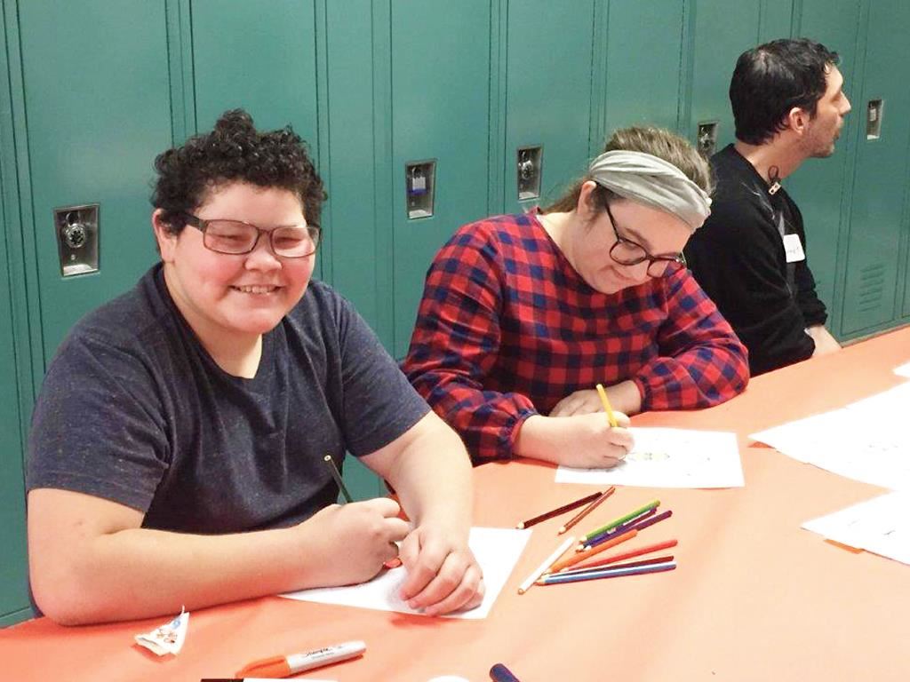 Students work at a table 